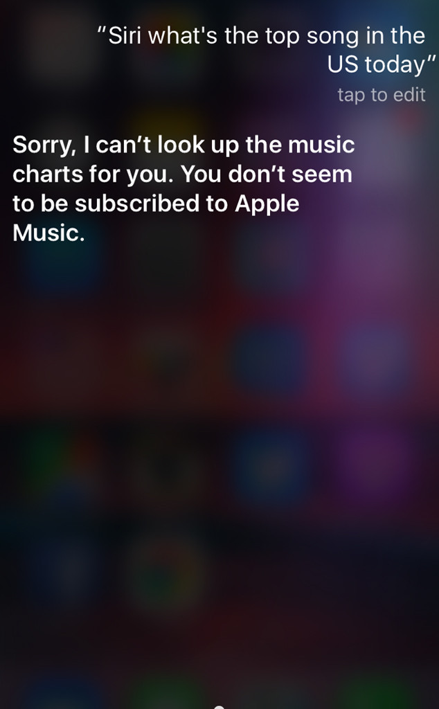 Screen shot of an iPhone engaging Siri. User asks: " Siri, what are the top songs in the US?" Siri responds: "Sorry, I can't look up the music charts for you, you don't seem to be subscribed to Apple Music. This image shows the intersection between Company propaganda and Artificial Intelligence personality.