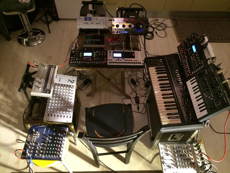 A single chair surrounded by a mass of electronic instruments. Links to longer description.