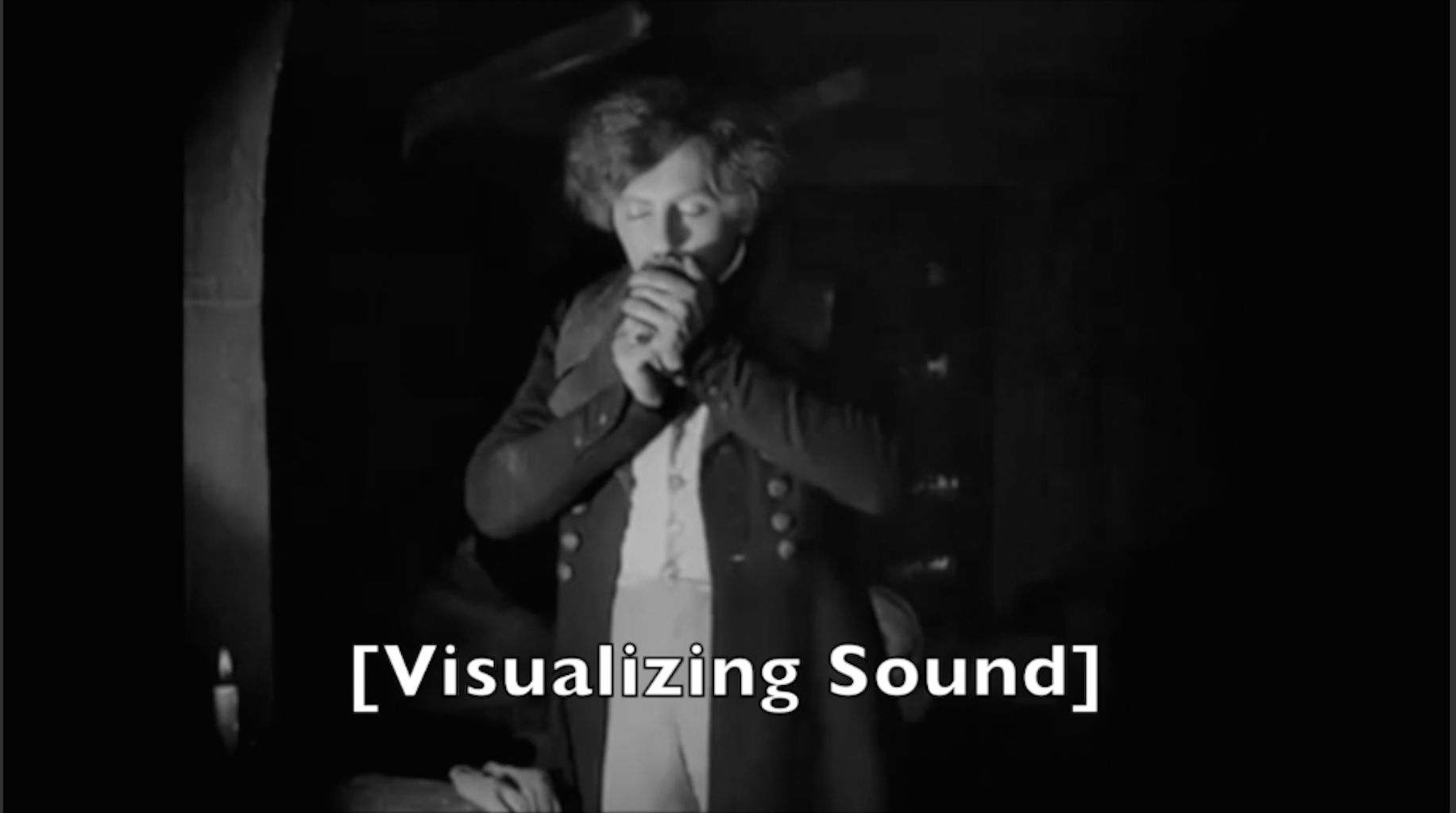 Image of a man kissing something in his hands, with a the title "Visualizing Sound" in brackets.
