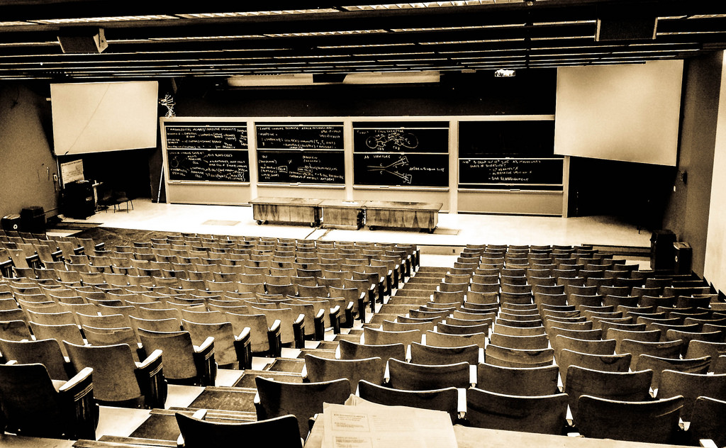 Sepia-tone photograph taken from the back of a large empty lecture hall