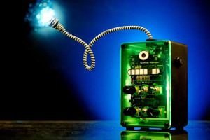 Image showing a small green electronic device, which powers a small light