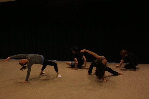 Image shows four actors performing various physical contortions against a black background.