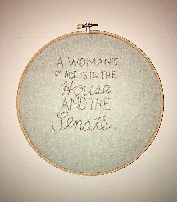 hoop cross stitch reads: "a woman's place is in the house and senate"