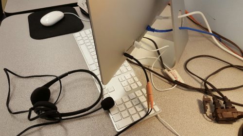 This is a picture of the headset chord (via the adapter) plugged into the desktop computer's headphone jack. There are a few other cords also going in and out of the computer.