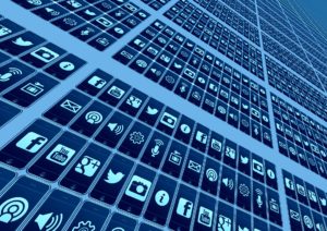 Diagonal matrix with rows and columns of mobile phones with different social media icons like Facebook, YouTube, and Twitter.