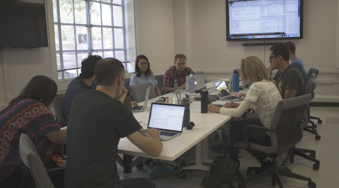 Lars Hinrichs, pictured center, leads the workshoppers through an intro to the language of R.