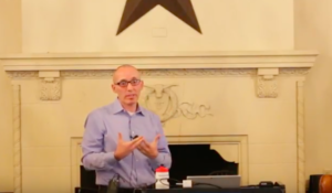 Professor David Rieder speaking at a podium