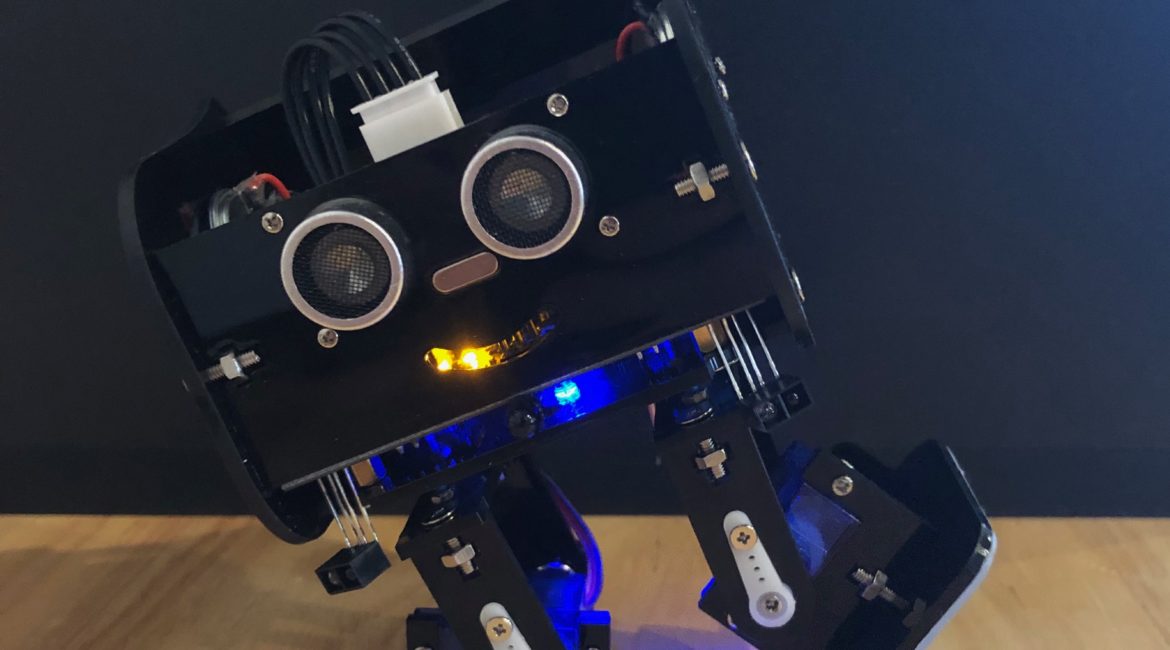 A Black, bipedal Arduino-based robot dancing