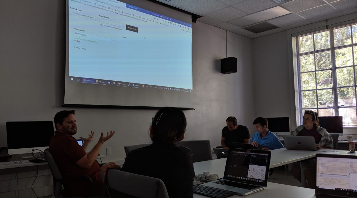 Instructor facilitating a workshop at the front of a classroom.